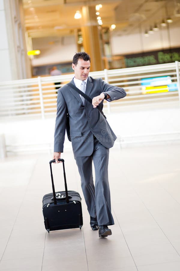 Businessman rushing in airport to catch a flight. Businessman rushing in airport to catch a flight