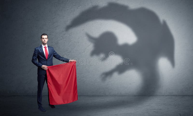 Businessman standing with red cloth in his hand and imp shadow on the background. Businessman standing with red cloth in his hand and imp shadow on the background