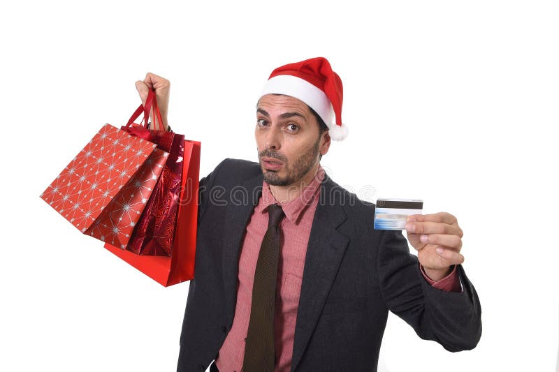 Zakenman in Santa Claus Christmas-hoedenholding die zakken en creditcard in ongerust gemaakt soppen en spanning stock afbeeldingen Zakenman in Santa Claus Christmas-hoedenholding die zakken en creditcard in ongerust gemaakt soppen en spanning stock afbeeldingen
