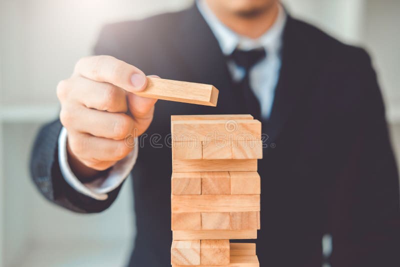 Businessman plan and strategy in business Domino Effect Leadership Management Solution concept. Businessman plan and strategy in business Domino Effect Leadership Management Solution concept.