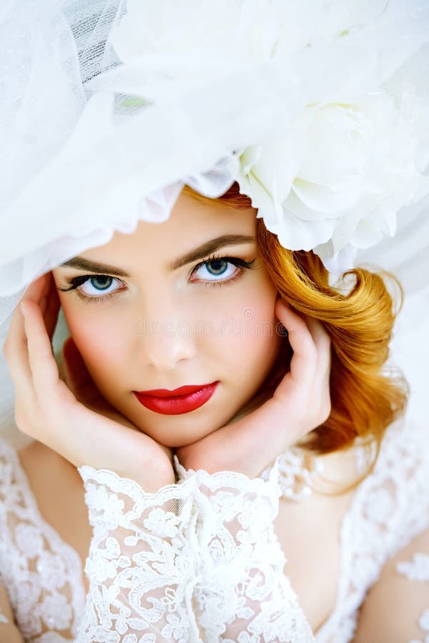 Close-up portrait of a charming bride in lace dress and elegant broad-brimmed hat. Wedding. Make-up and hairstyle. Beauty, fashion. Close-up portrait of a charming bride in lace dress and elegant broad-brimmed hat. Wedding. Make-up and hairstyle. Beauty, fashion.