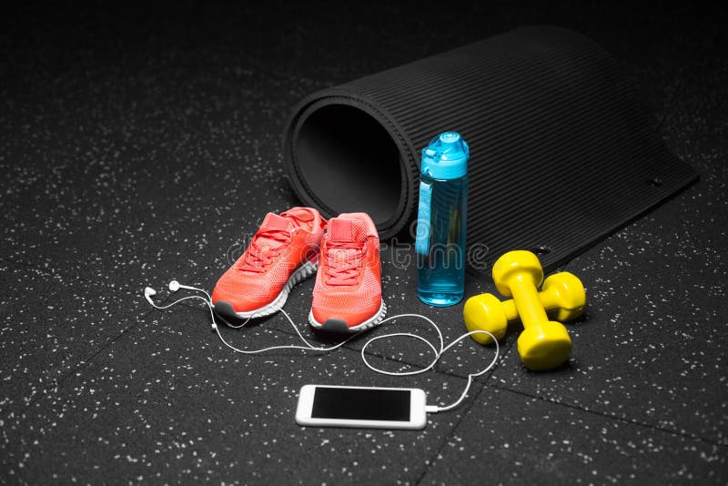 Zakończenie szkolenie buty, gumy mata, dumbbells, błękitna butelka i telefon na czarnym łaciastym tle, kosmos kopii zdjęcia stock Zakończenie szkolenie buty, gumy mata, dumbbells, błękitna butelka i telefon na czarnym łaciastym tle, kosmos kopii zdjęcia stock
