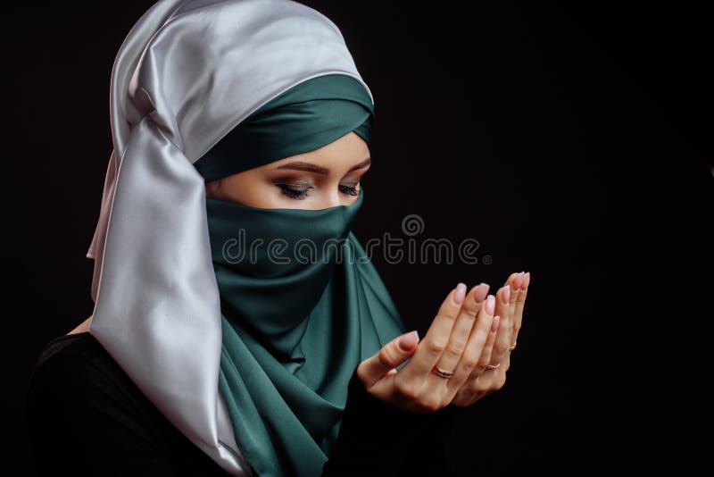 Close up side view shot of Islamic woman with closed eyes has converted to Islam. Muslim beahaviour. Islam traditions. ask forgiveness for sins and errors. Close up side view shot of Islamic woman with closed eyes has converted to Islam. Muslim beahaviour. Islam traditions. ask forgiveness for sins and errors