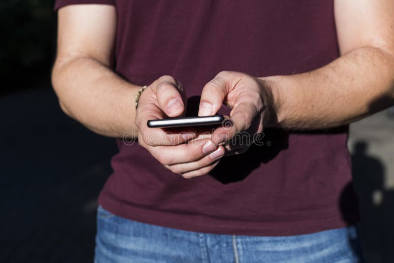 Zakończenie w górę widoku mężczyzna wręcza pisać na maszynie na mądrze telefonie Przypadkowy clothin obraz stock Zakończenie w górę widoku mężczyzna wręcza pisać na maszynie na mądrze telefonie Przypadkowy clothin obraz stock