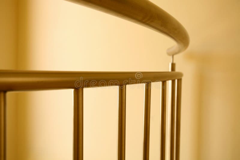 A curved steel railing isolated against a wall. A curved steel railing isolated against a wall.