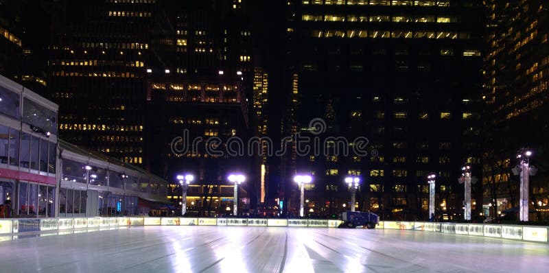 Ice skaters patiently wait in the pavilion while the Zamboni resurfaces the ice at the skating rink at the Winter Village at Bryant Park. Lights in the surrounding office buildings illuminate the nighttime skyline. Ice skaters patiently wait in the pavilion while the Zamboni resurfaces the ice at the skating rink at the Winter Village at Bryant Park. Lights in the surrounding office buildings illuminate the nighttime skyline.