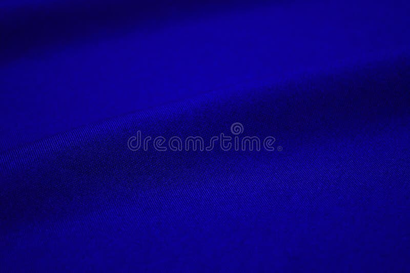 Blue fabric closeup. Plexus threads. Clothing industry. Abstract background. Textile waves. Blue fabric closeup. Plexus threads. Clothing industry. Abstract background. Textile waves.