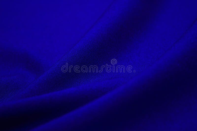Blue fabric closeup. Plexus threads. Clothing industry. Abstract background. Textile waves. Blue fabric closeup. Plexus threads. Clothing industry. Abstract background. Textile waves.