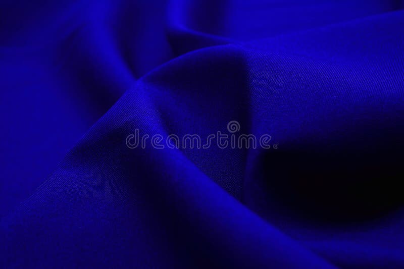 Blue fabric closeup. Plexus threads. Clothing industry. Abstract background. Textile waves. Blue fabric closeup. Plexus threads. Clothing industry. Abstract background. Textile waves.