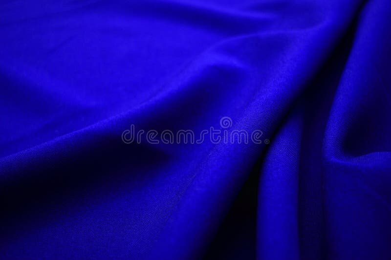 Blue fabric closeup. Plexus threads. Clothing industry. Abstract background. Textile waves. Blue fabric closeup. Plexus threads. Clothing industry. Abstract background. Textile waves.