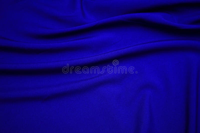 Blue fabric closeup. Plexus threads. Clothing industry. Abstract background. Textile waves. Blue fabric closeup. Plexus threads. Clothing industry. Abstract background. Textile waves.