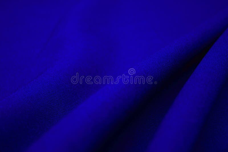 Blue fabric closeup. Plexus threads. Clothing industry. Abstract background. Textile waves. Blue fabric closeup. Plexus threads. Clothing industry. Abstract background. Textile waves.