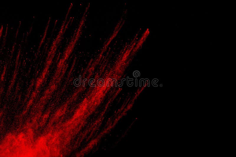 Zamrażać ruch czerwonych cząstek pyłu barwnego rozpryskiwanych fotografia royalty free