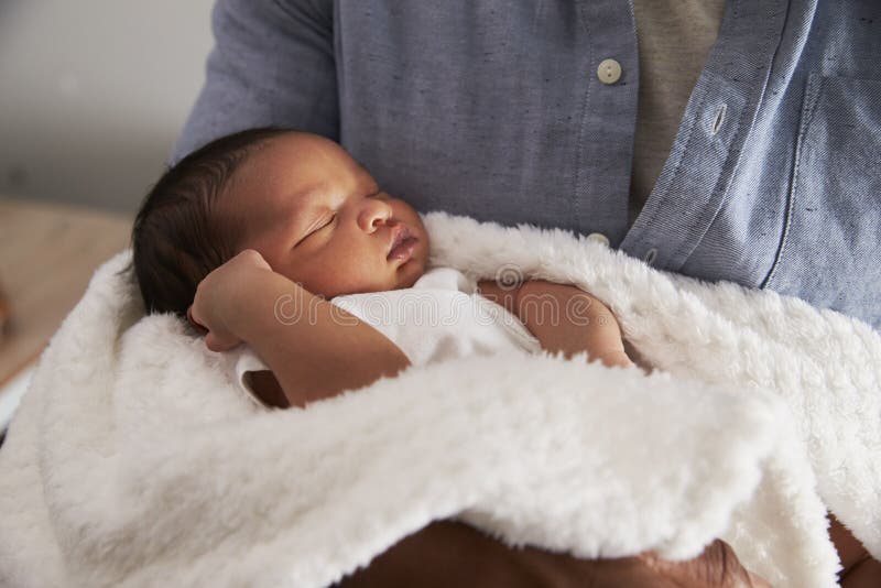 Close Up Of Father Holding Newborn Baby Son In Nursery. Close Up Of Father Holding Newborn Baby Son In Nursery