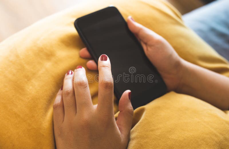 Zamyka w górę młodego żeńskiego używa smartphone na kanapie technologii nowoczesnego życia i komunikacji pojęcia obrazy stock Zamyka w górę młodego żeńskiego używa smartphone na kanapie technologii nowoczesnego życia i komunikacji pojęcia obrazy stock
