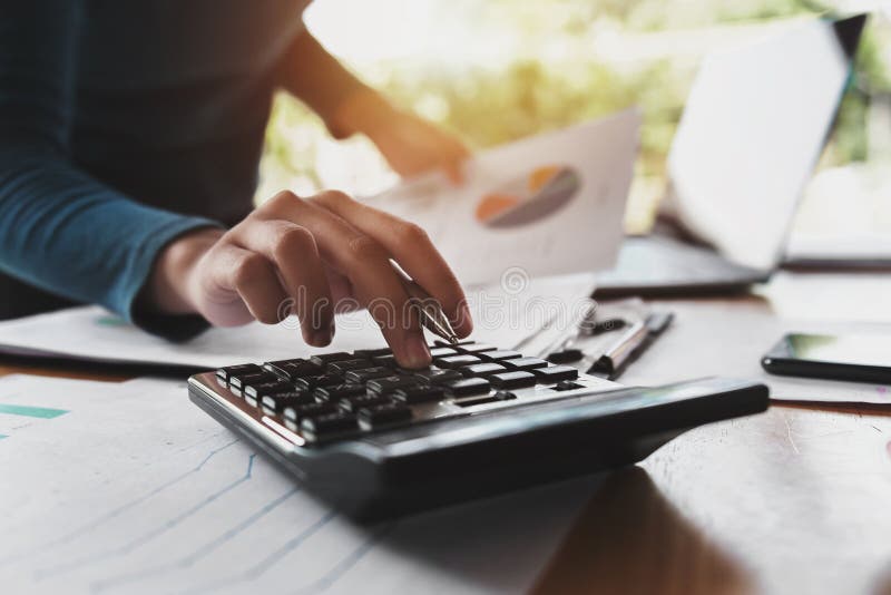 close up hand of business woman using calculator for working in office. close up hand of business woman using calculator for working in office