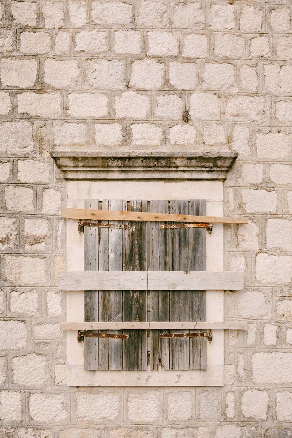 Close-up of a window with closed shutters and hammered boards. High quality photo. Close-up of a window with closed shutters and hammered boards. High quality photo