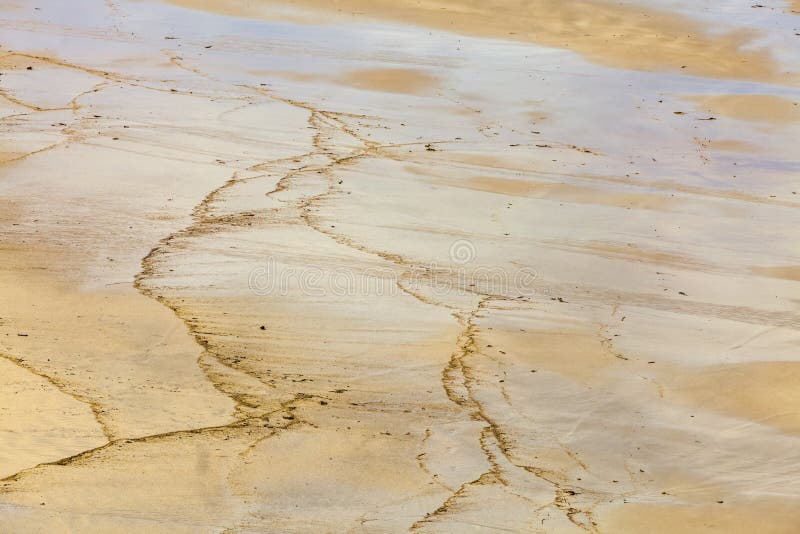 Detail of wet sand on a beach after the waves. Detail of wet sand on a beach after the waves.