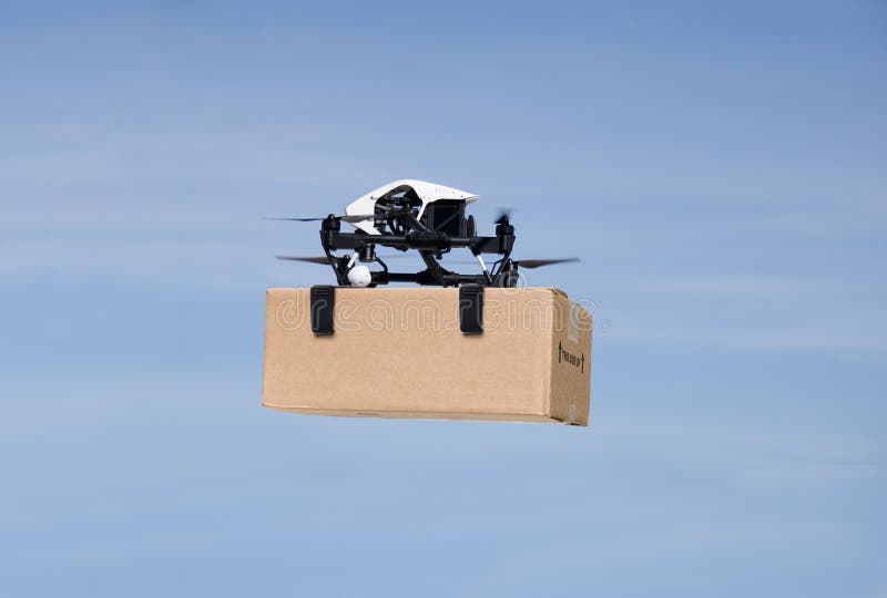 Drone flying through the air with a delivery box pakage clamped on to deliver to customer. Drone flying through the air with a delivery box pakage clamped on to deliver to customer