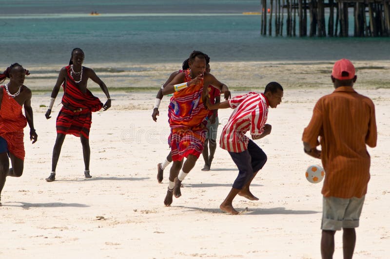 Zanzibar Tanzania 14/08/2010:   Masai playing soccer with tourists. Zanzibar Tanzania 14/08/2010:   Masai playing soccer with tourists