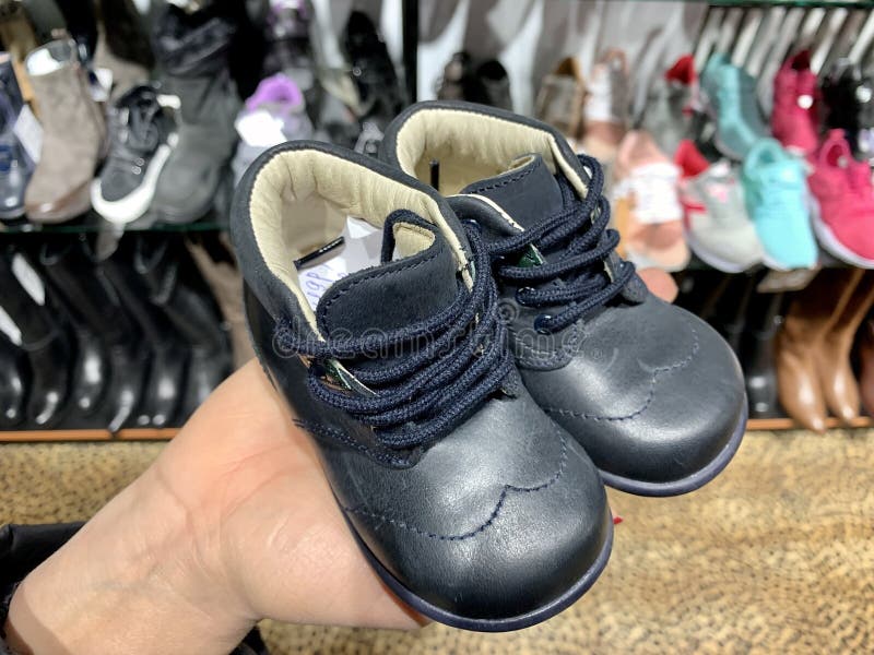 Zapatos De Cuero Para Niños En Pequeños Zapatos En La Palma De La Mano Zapatos Para El Bebé En La Tienda Foto de archivo - Imagen de manos, bebé: 168379666