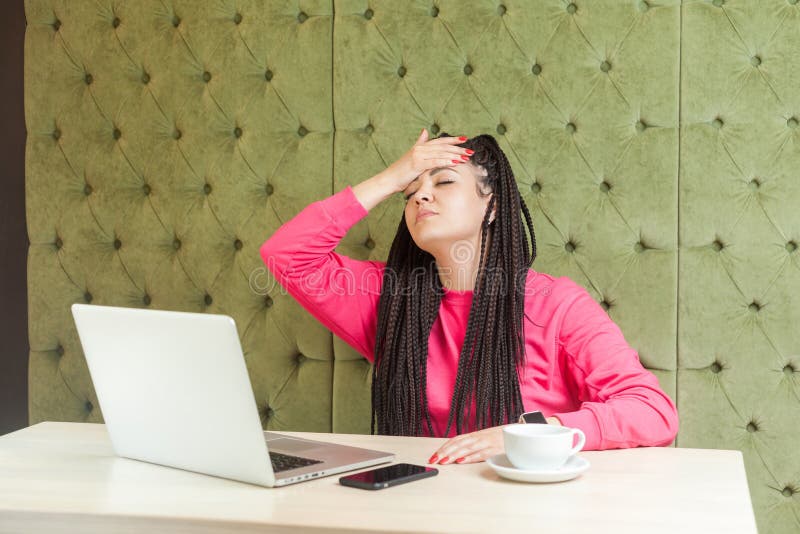 I forget! Portrait of depressed young girl with black dreadlocks hairstyle in pink blouse are sitting in cafe and having big problem, holding hand on forehead with closed eyes and upset face. Indoor. I forget! Portrait of depressed young girl with black dreadlocks hairstyle in pink blouse are sitting in cafe and having big problem, holding hand on forehead with closed eyes and upset face. Indoor