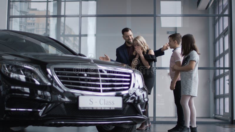 Happy family getting new car in salon stock photos Happy family getting new car in salon stock photos