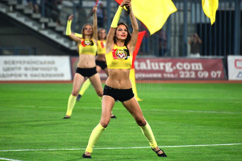 girls with flags photo was taken during the match between metalurg zaporozhye city and dnipro dnipropetrovsk city at stadium. girls with flags photo was taken during the match between metalurg zaporozhye city and dnipro dnipropetrovsk city at stadium