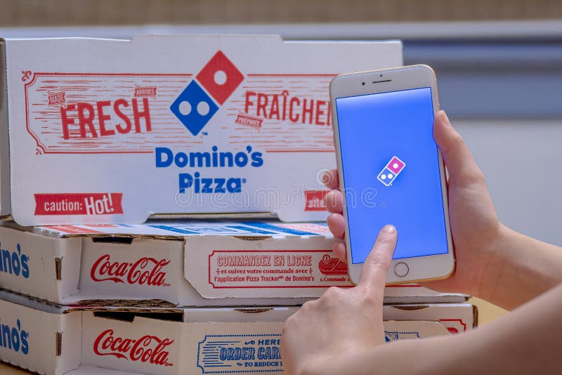 Zbliżenie osoby używającej aplikacji Domino's Pizza na telefonie iPhone Plus Pizza Domino fotografia royalty free
