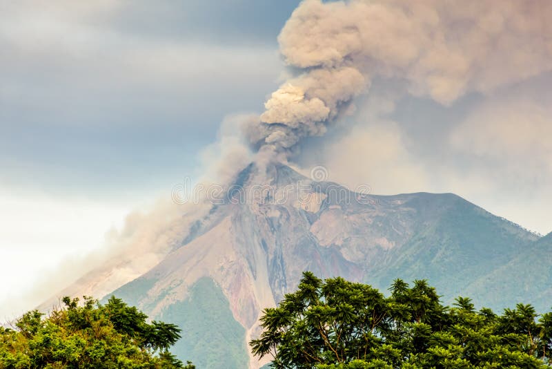 Smoke billows from erupting Fuego volcano just after dawn near Antigua, Guatemala, Central America. Smoke billows from erupting Fuego volcano just after dawn near Antigua, Guatemala, Central America