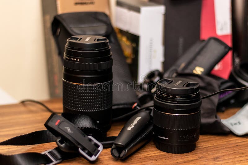 BOLINGBROOK, UNITED STATES - Mar 03, 2019: A closeup picture of digital camera lenses on a wooden table in the United States in Bolingbrook. BOLINGBROOK, UNITED STATES - Mar 03, 2019: A closeup picture of digital camera lenses on a wooden table in the United States in Bolingbrook