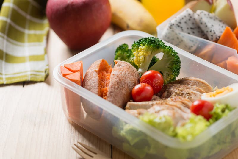 Healthy lunch boxes in plastic package, Grilled chicken breast with sweet potato, egg and vegetable salad, fruit, orange juice. Diet food concept. Healthy lunch boxes in plastic package, Grilled chicken breast with sweet potato, egg and vegetable salad, fruit, orange juice. Diet food concept.
