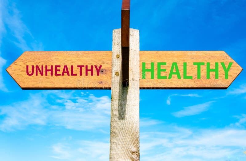 Wooden signpost with two opposite arrows over clear blue sky, Healthy versus Unhealthy messages, Healthy Lifestyle conceptual image. Wooden signpost with two opposite arrows over clear blue sky, Healthy versus Unhealthy messages, Healthy Lifestyle conceptual image