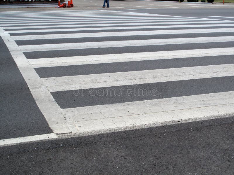 A very wide zebra pedestrian crossing. A very wide zebra pedestrian crossing.