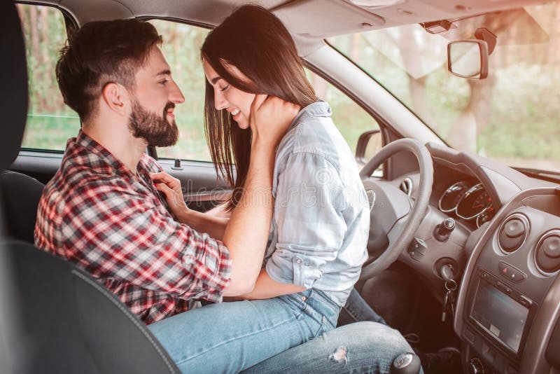 Zeer teder beeld van jonge paarzitting face to face in auto Hij houdt zijn hand op haar hals en bekijkt meisje stock foto's Zeer teder beeld van jonge paarzitting face to face in auto Hij houdt zijn hand op haar hals en bekijkt meisje stock foto's
