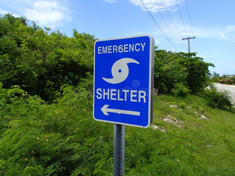 A sign showing the way to the emergency shelter for hurricanes in the Caribbean. A sign showing the way to the emergency shelter for hurricanes in the Caribbean