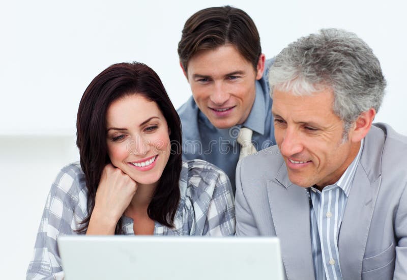 Confident business partners working at a computer in an office. Confident business partners working at a computer in an office