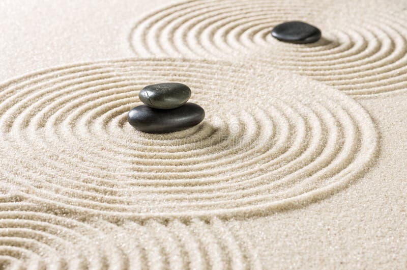 A zen garden with black pebbles royalty free stock image
