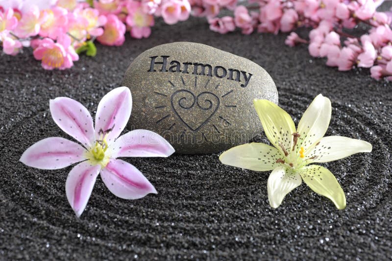 Zen garden of harmony. Zen garden in black sand with stone of harmony royalty free stock photos