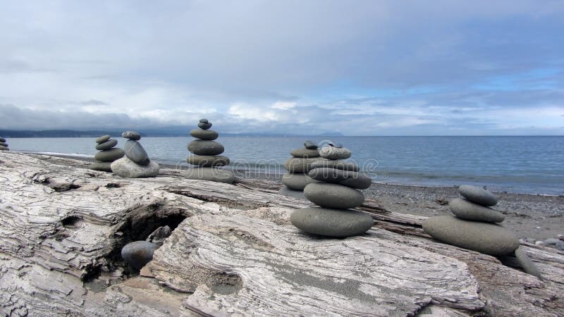 Zen Rocks on the beach in Washington State at the Dungeness Spit with driftwood. Zen Rocks on the beach in Washington State at the Dungeness Spit with driftwood