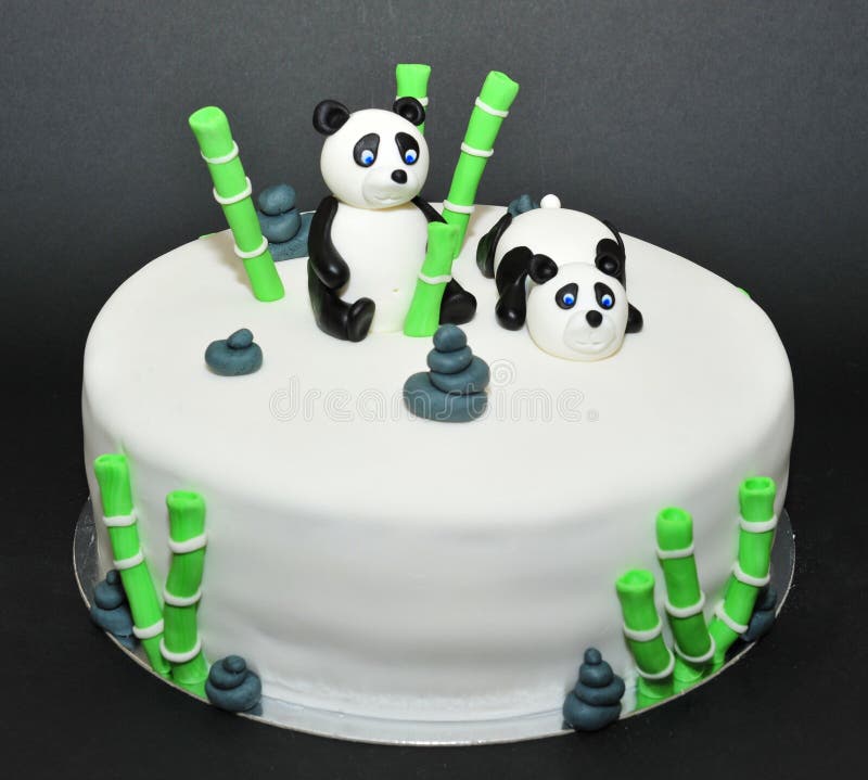 Beautifully crafted cake with panda bears fondant figurines. Beautifully crafted cake with panda bears fondant figurines