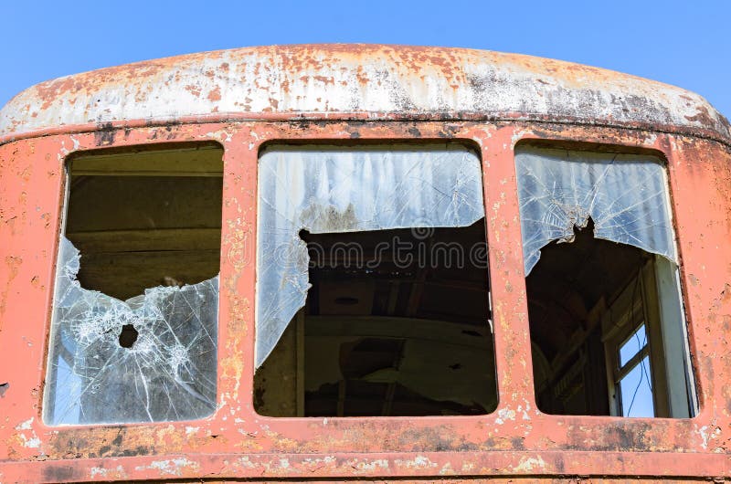 Broken window of a red rusted train, abandoned train. Broken window of a red rusted train, abandoned train.