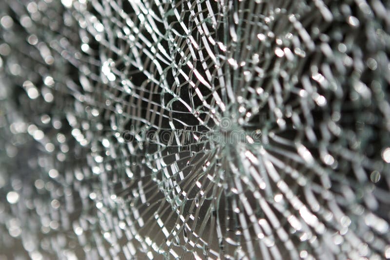 A glass pane with radial shatter pattern. A glass pane with radial shatter pattern