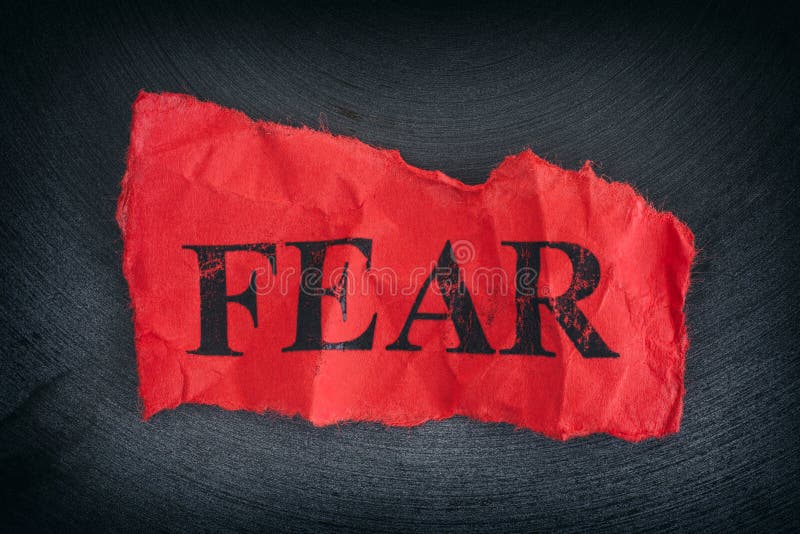 Crumpled piece of paper with the word Fear. Close up. Crumpled piece of paper with the word Fear. Close up.