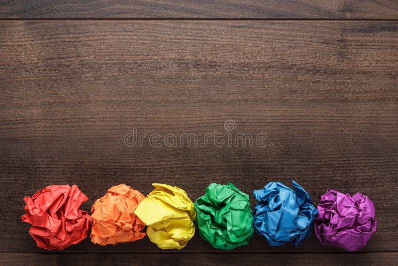 Crumpled colorful paper on wooden background creative process. Crumpled colorful paper on wooden background creative process.