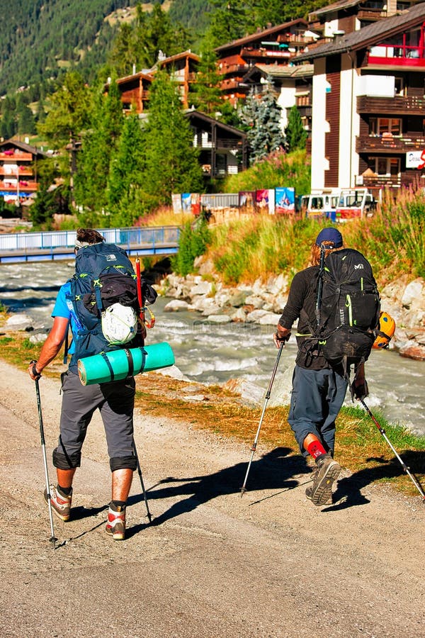 Zermatt, Switzerland - August 24, 2016: People doing nordic walking in resort city Zermatt in Switzerland in summer stock images Zermatt, Switzerland - August 24, 2016: People doing nordic walking in resort city Zermatt in Switzerland in summer stock images