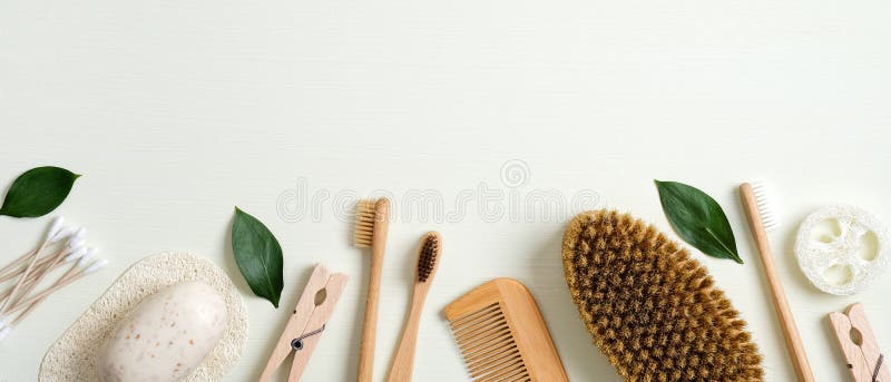 Zero waste bathroom accessories. Frame border of cotton ear sticks, handmade soap, wooden pin, bamboo toothbrushes, hair comb