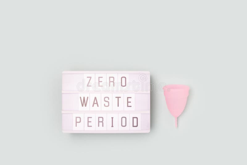 Zero Waste Period. Lightbox with Letters and Menstrual Cup on a Blue
