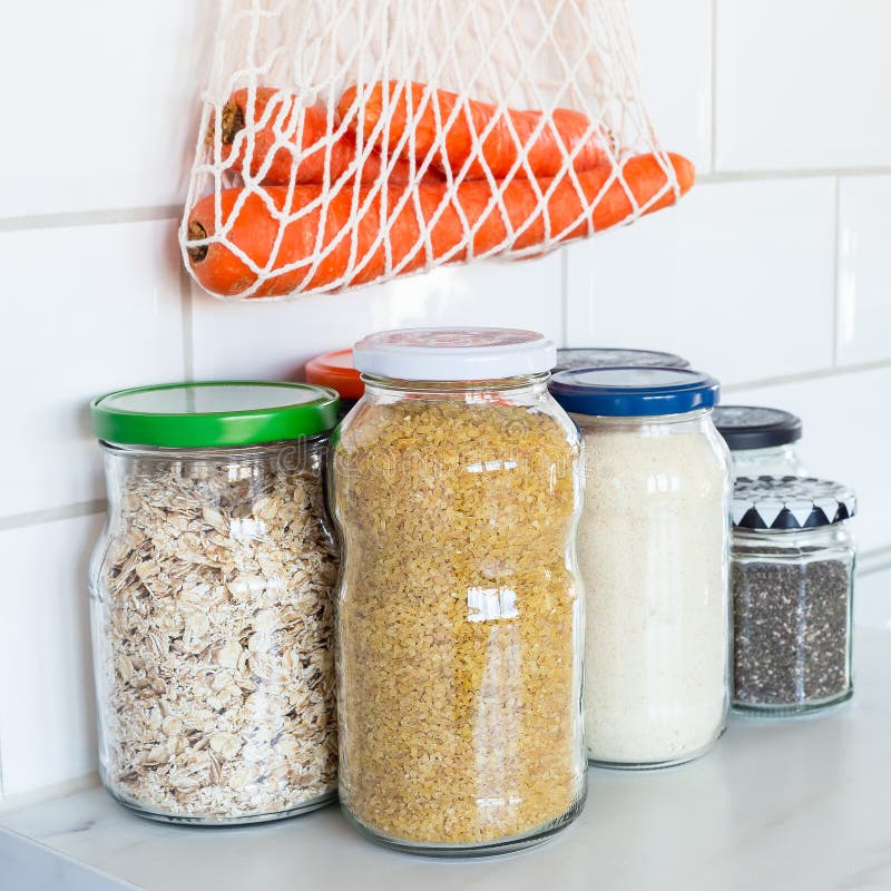 Zero waste plastic-free concept at home, different food in reused glass jars and mesh bag on the kitchen, square format. Zero waste plastic-free concept at home royalty free stock photos Zero waste plastic-free concept at home, different food in reused glass jars and mesh bag on the kitchen, square format. Zero waste plastic-free concept at home royalty free stock photos