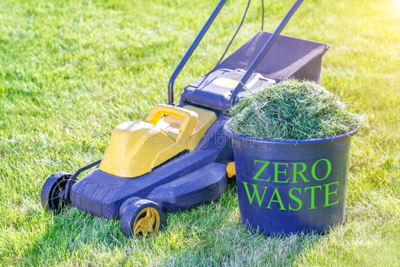 Zero Waste Theme. Container with Fresh Grass for Compost and Lawn Mower